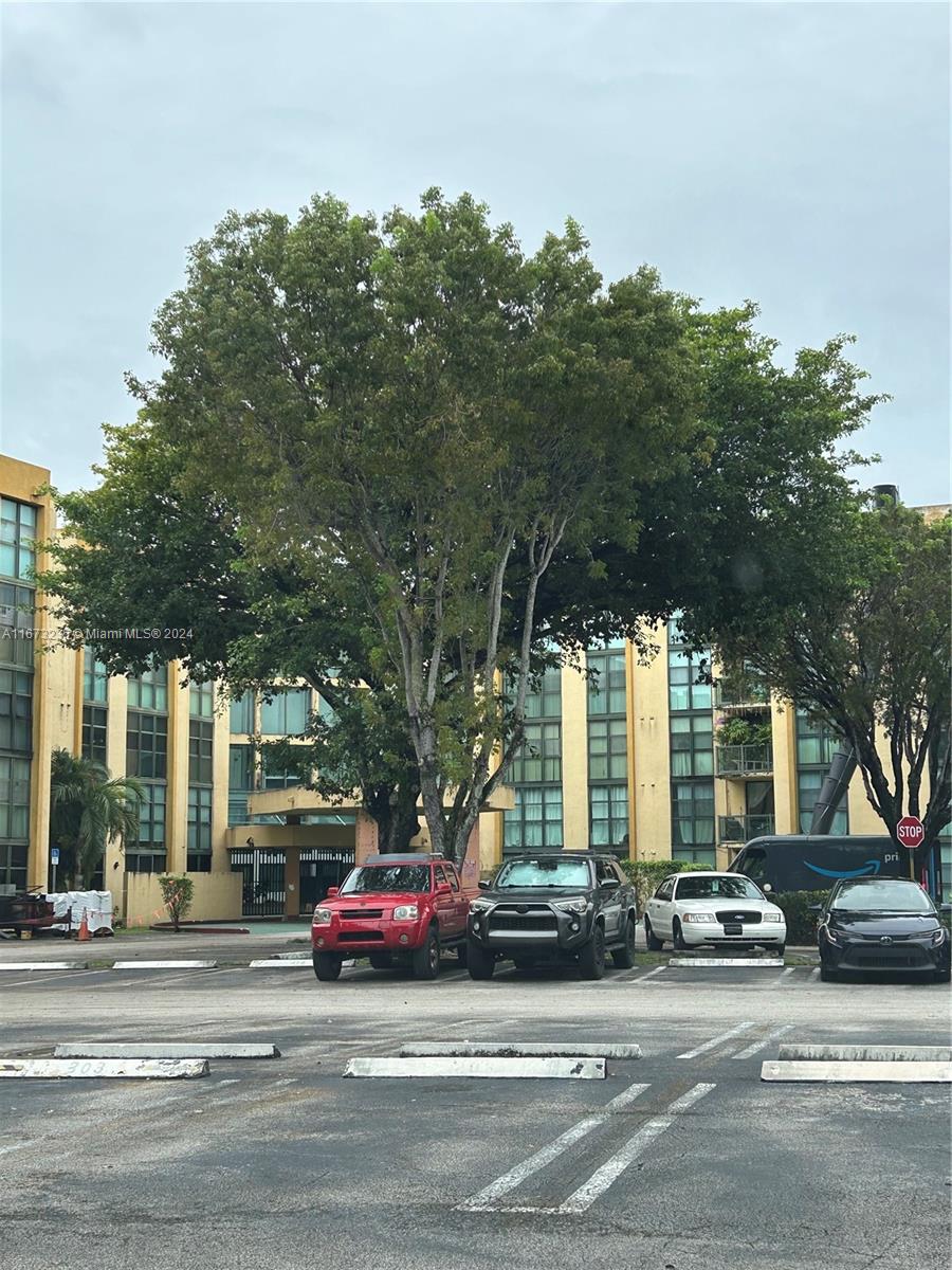 a view of a cars parked on the side of a street