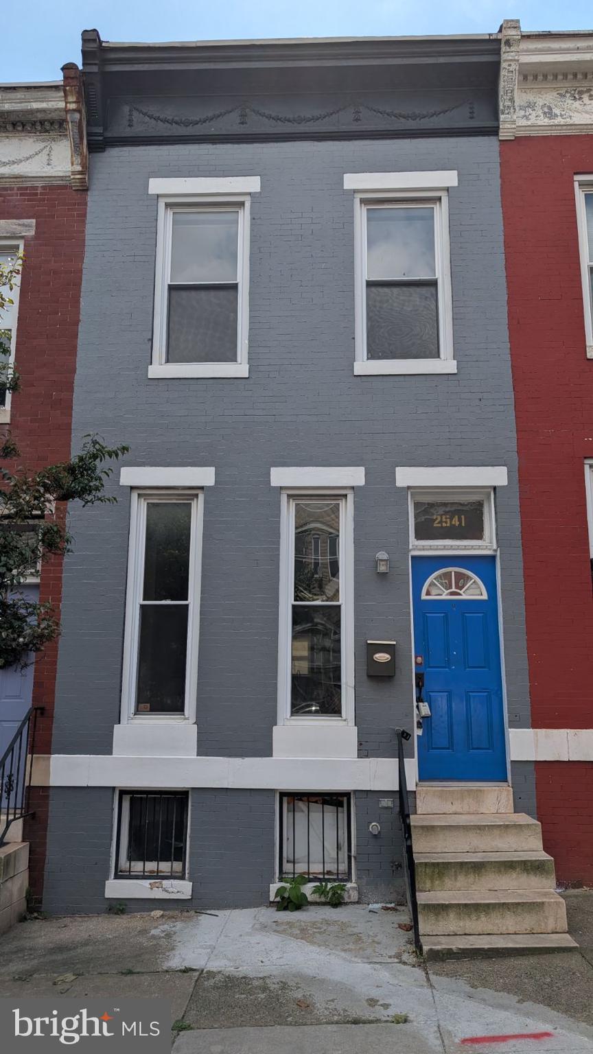 a front view of residential houses with stairs