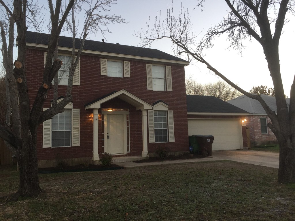 a front view of a house with a yard