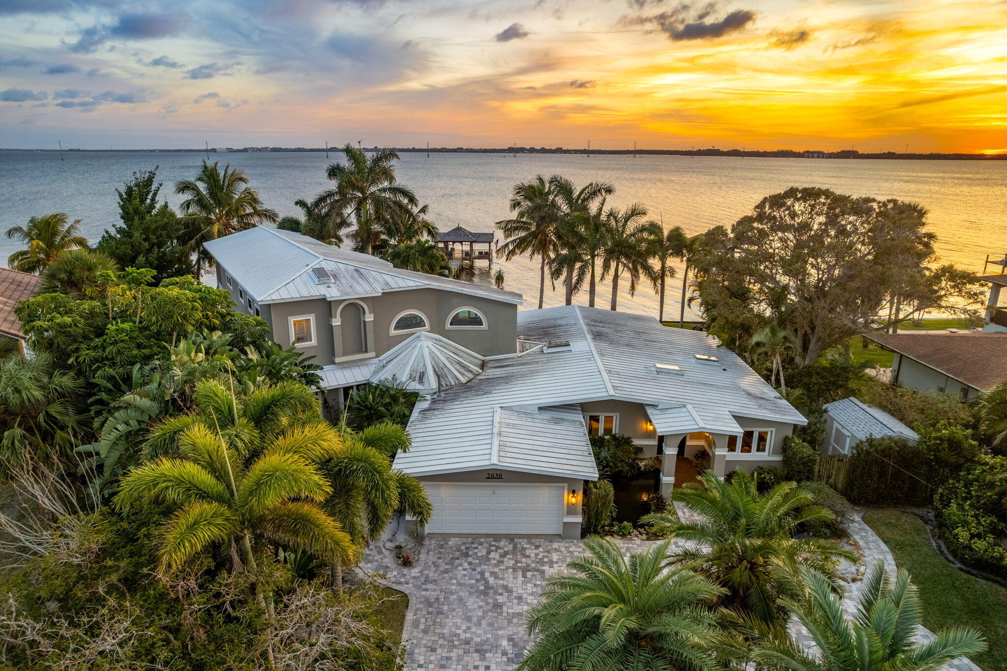 an aerial view of multiple houses with a yard