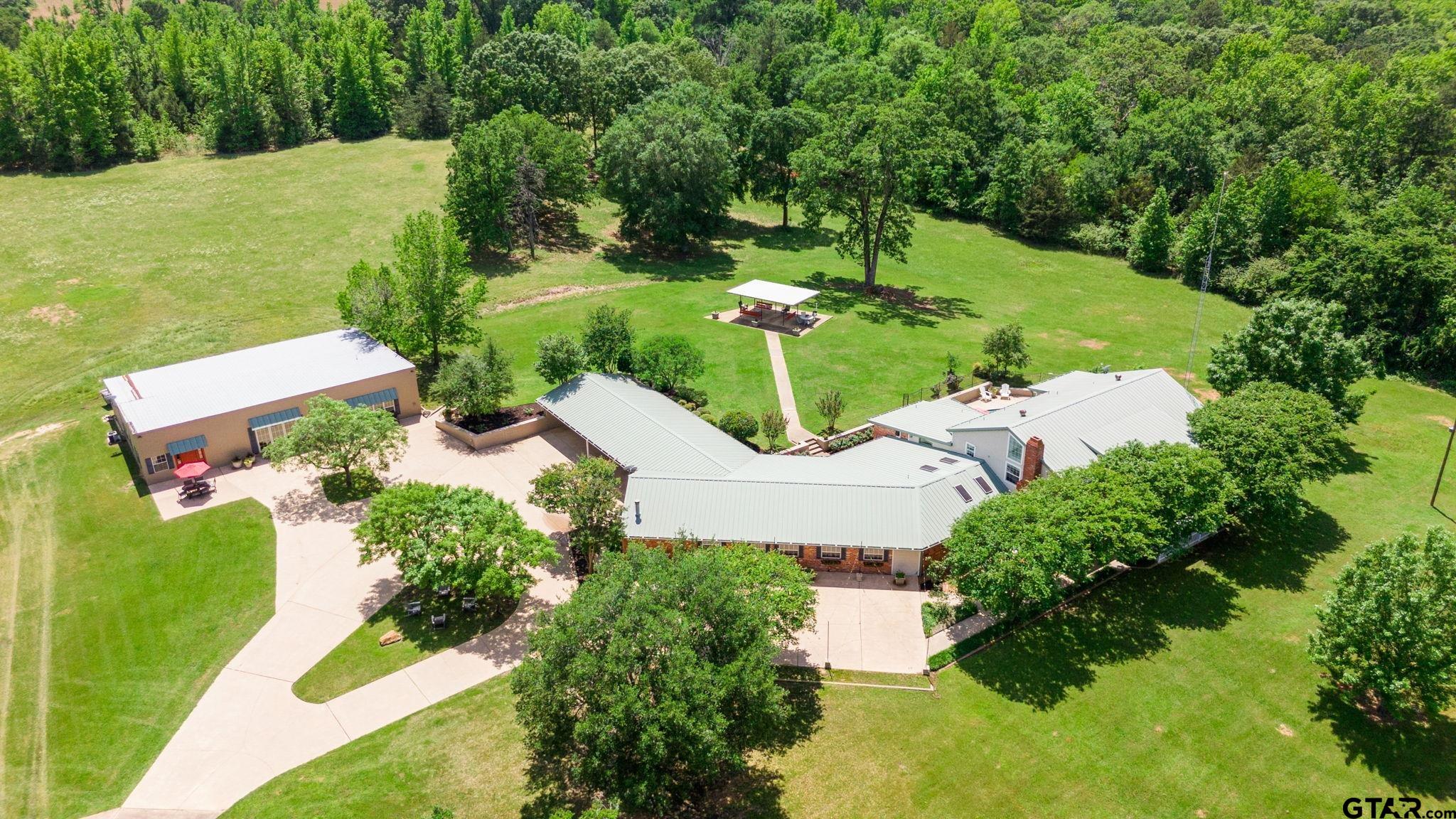 an aerial view of a house with yard