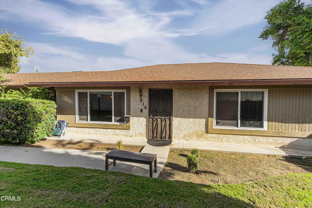 a front view of a house with a yard outdoor seating and barbeque oven