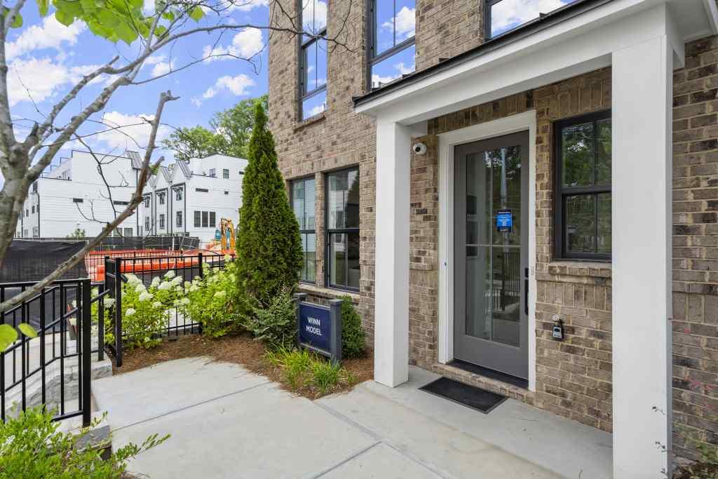 a view of a brick house with a flower garden