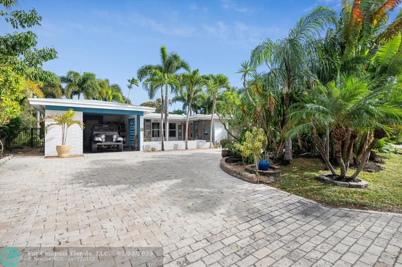 a view of a house with a yard and a garage