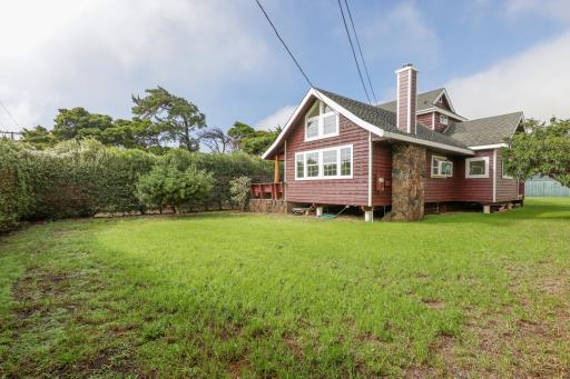 a front view of a house with a garden and plants