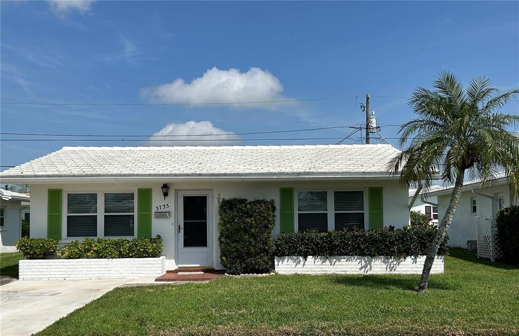 a view of a house with a yard and plants