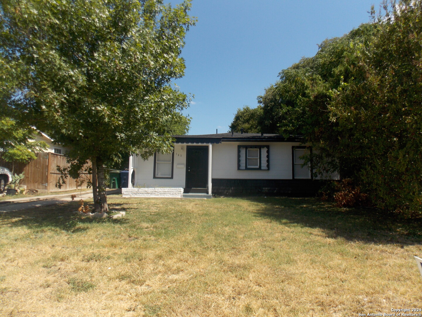 a view of a house with pool and a tree