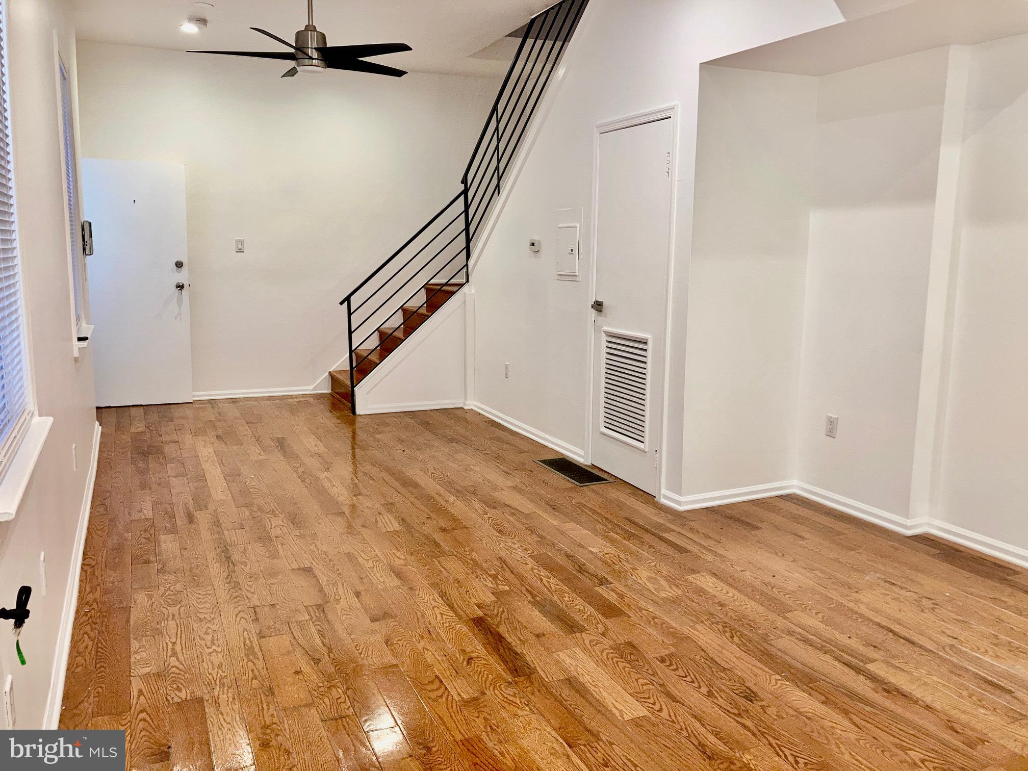 a view of an entryway with wooden floor