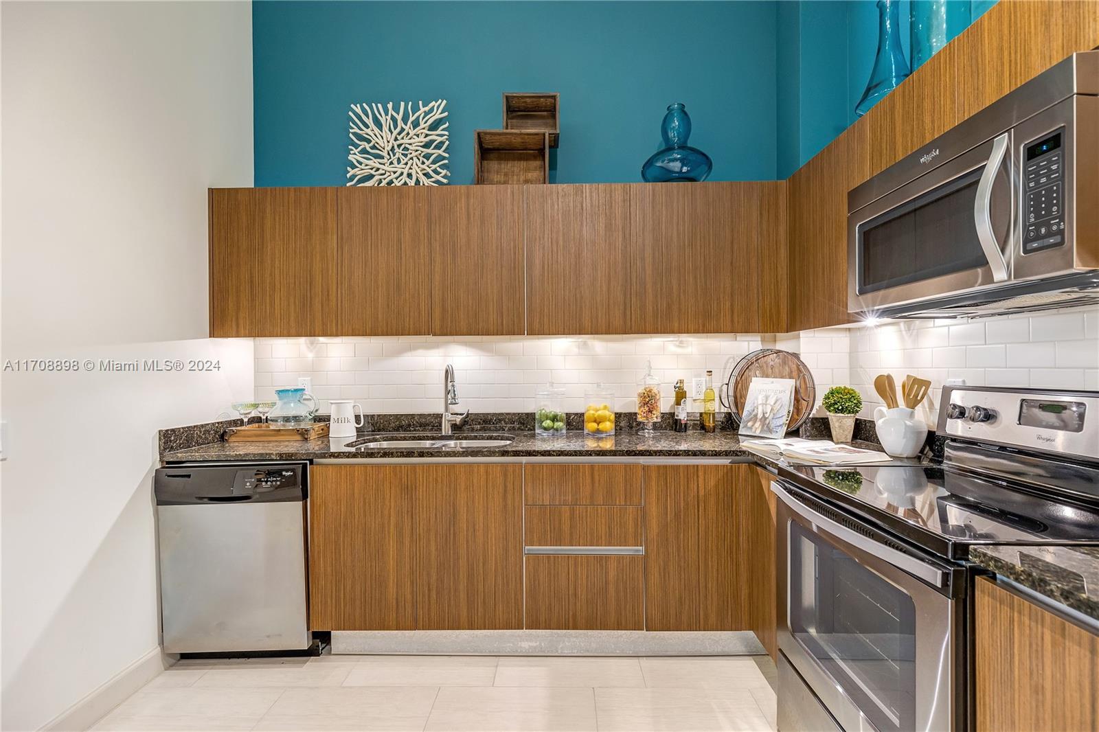 a kitchen with stainless steel appliances granite countertop a stove a sink dishwasher and cabinets