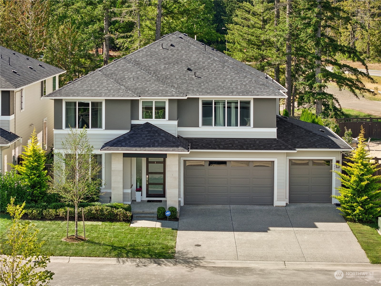 a front view of a house with a yard and garage