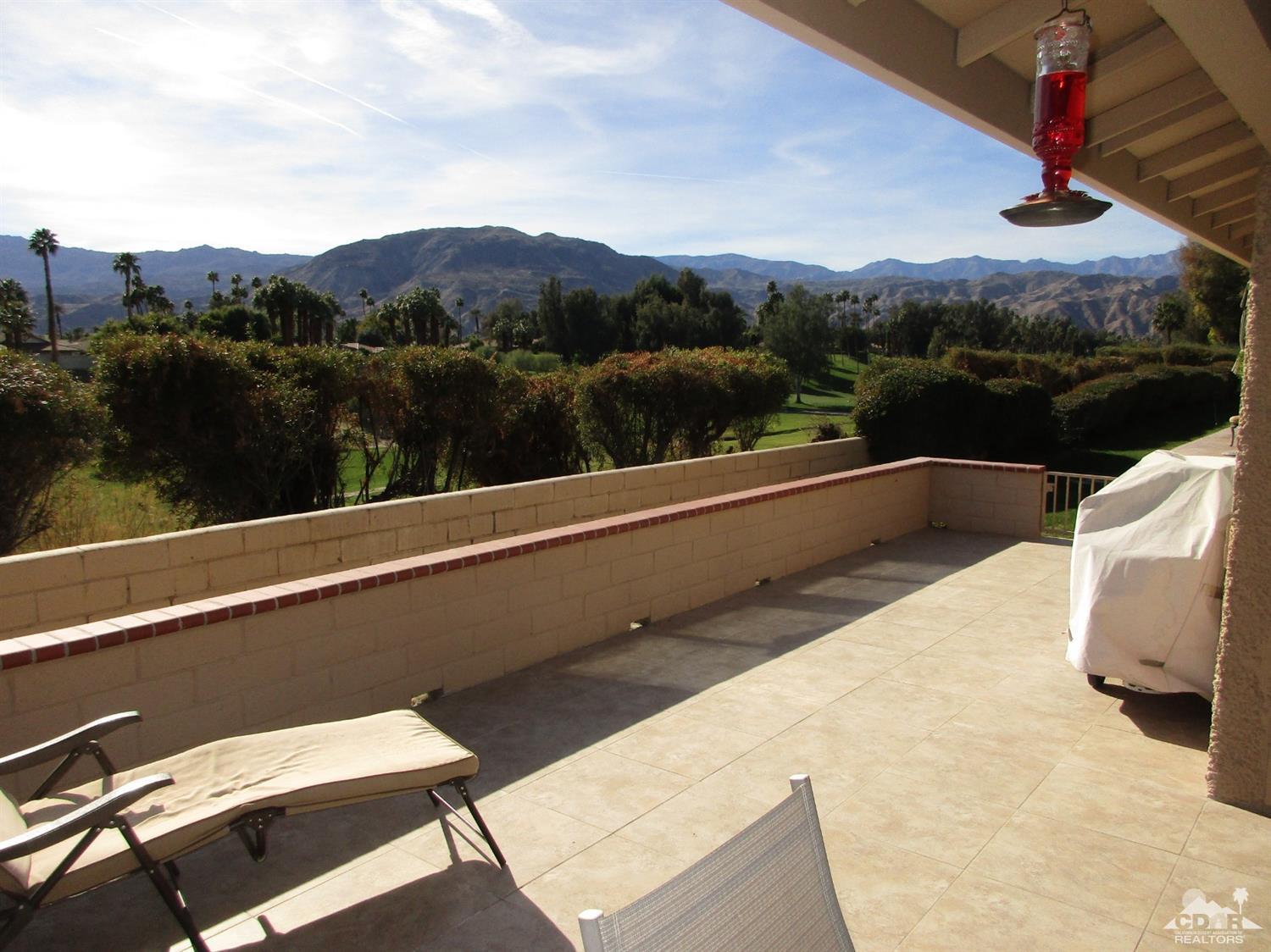 a view of balcony with furniture