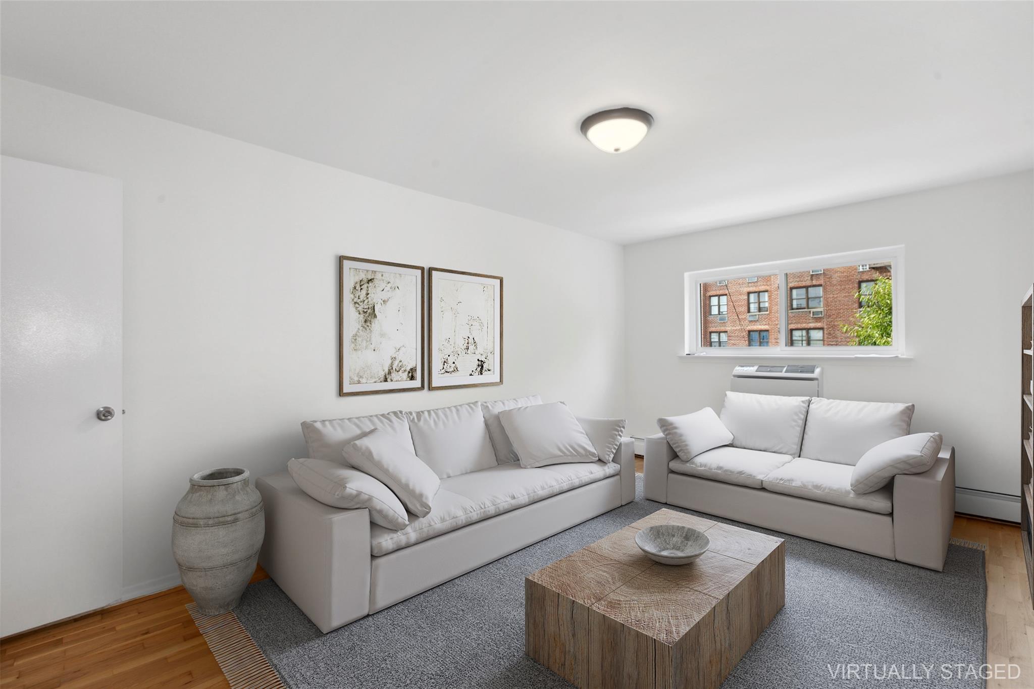 Living room featuring wood-type flooring and a baseboard radiator