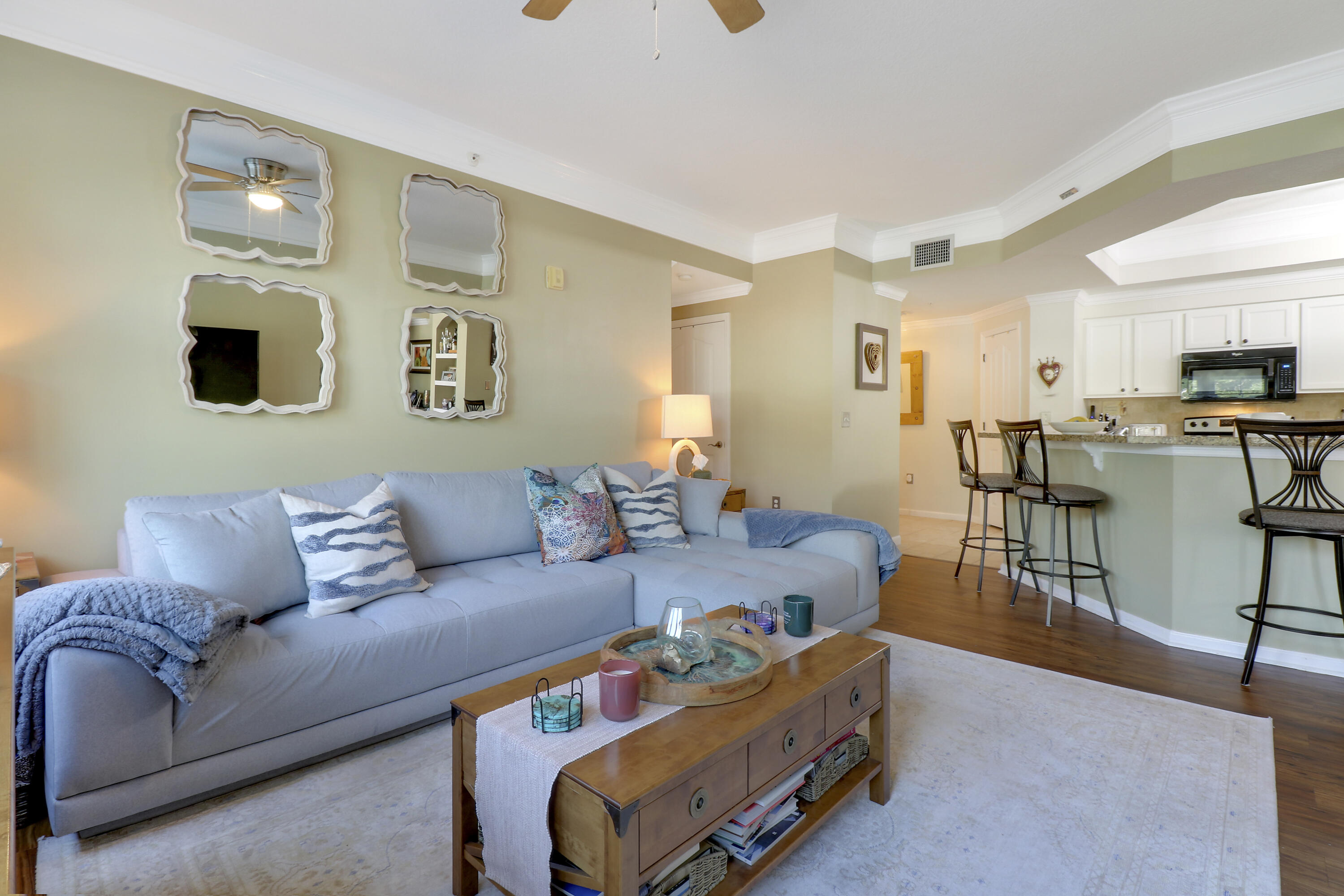 a living room with furniture and kitchen view