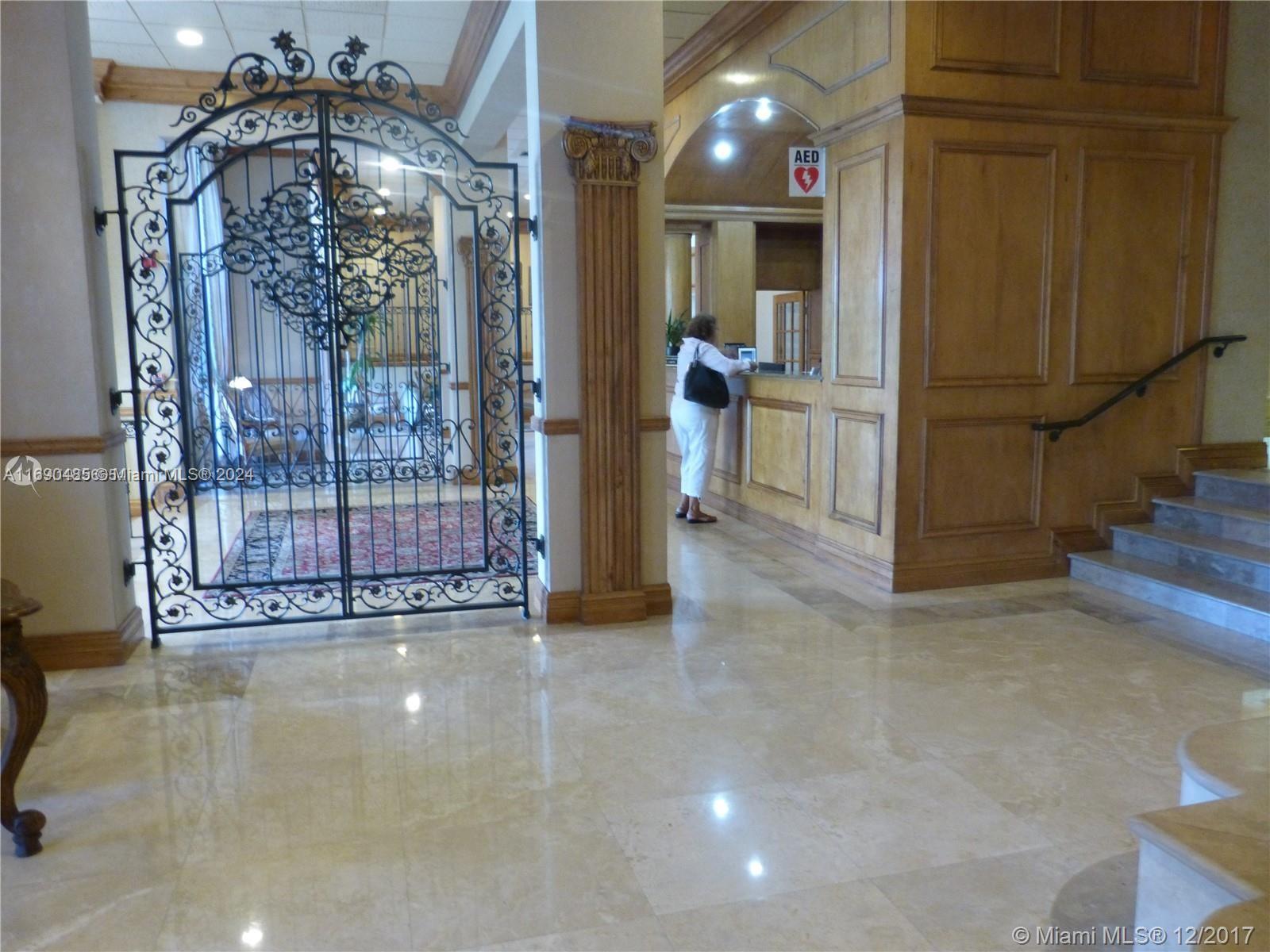 a view of a hallway with dining area and chandelier