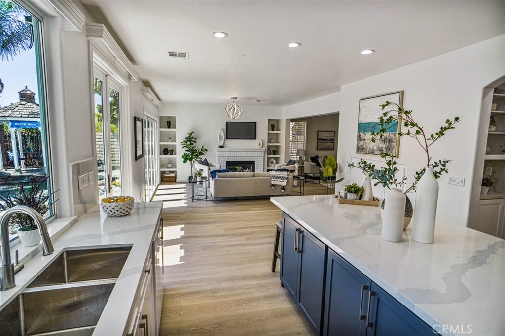 a kitchen with sink stove and living room