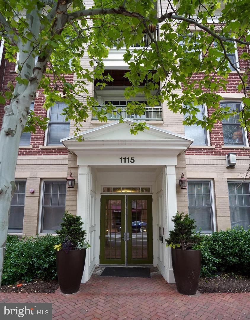 a front view of a building with potted plants