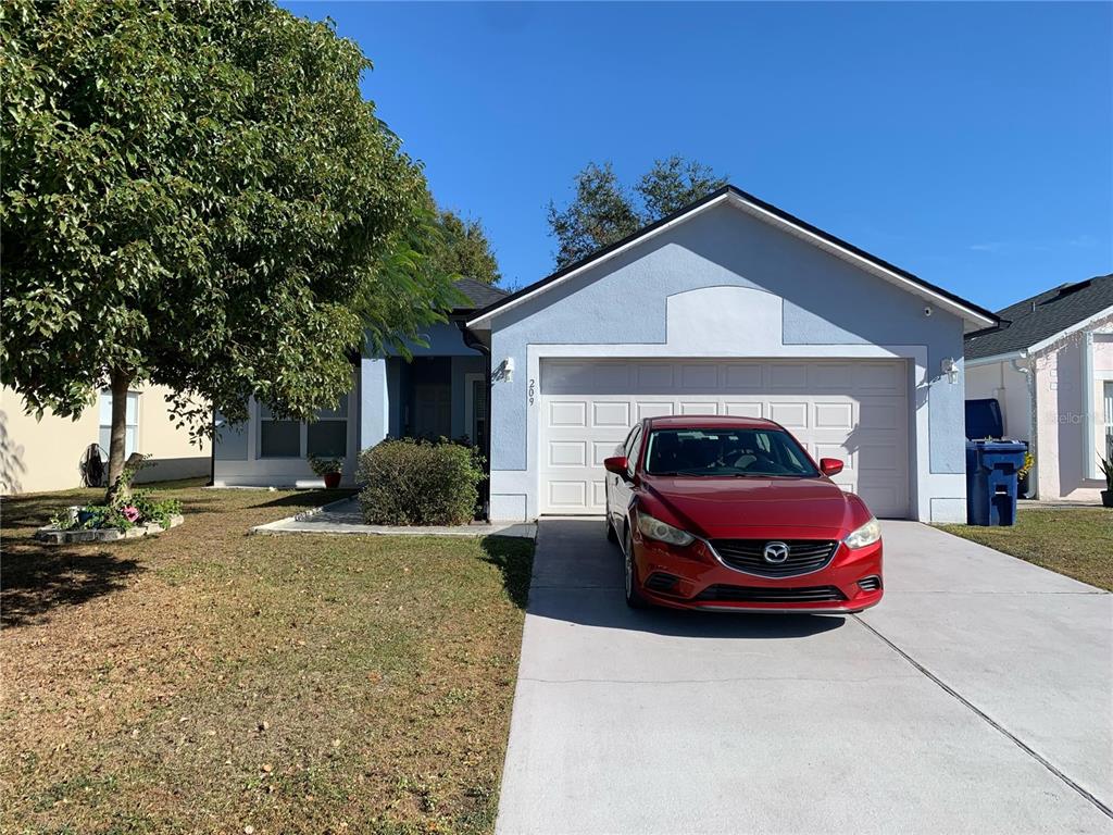 a front view of a house with parking space