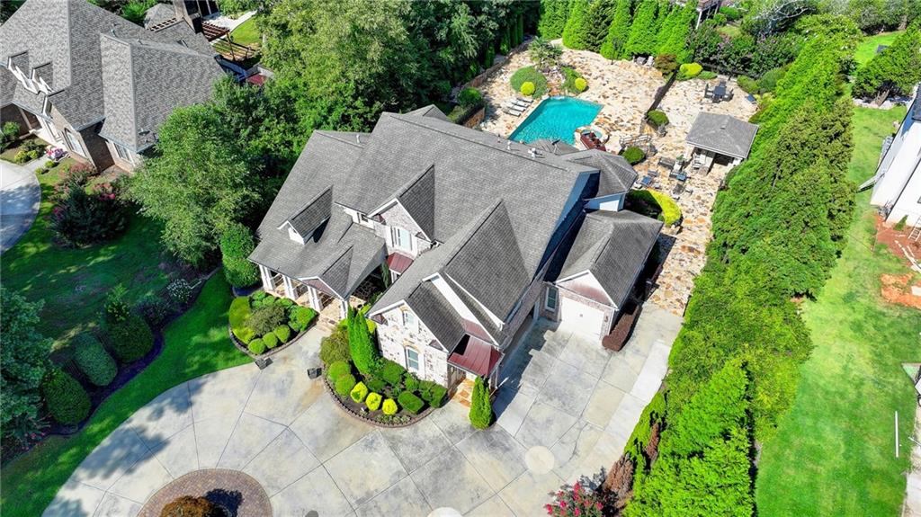 an aerial view of a house with a garden and swimming pool