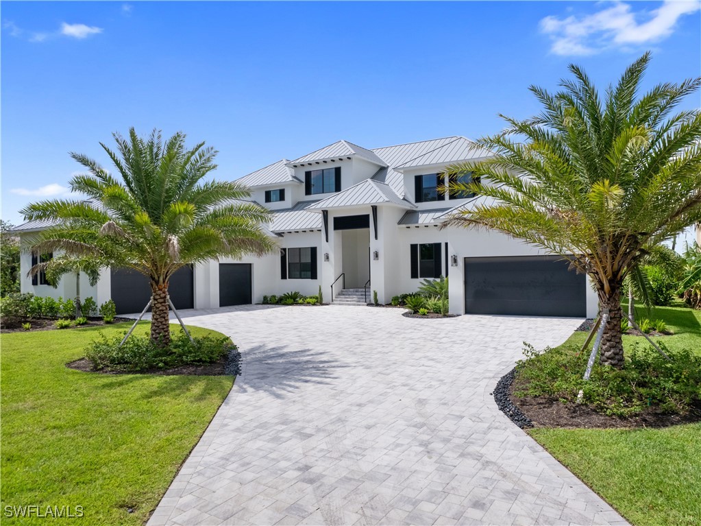 a front view of a house with a yard and garage