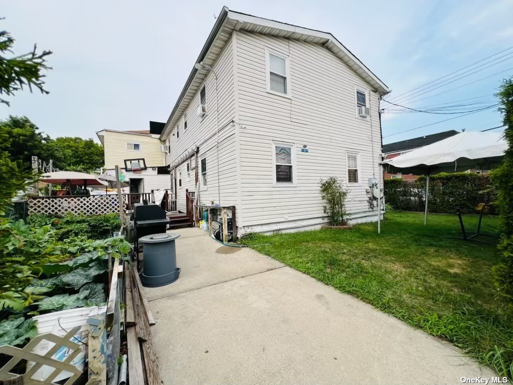 a view of backyard of house with seating space