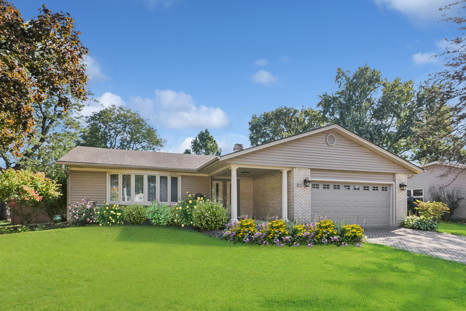 a front view of a house with a garden