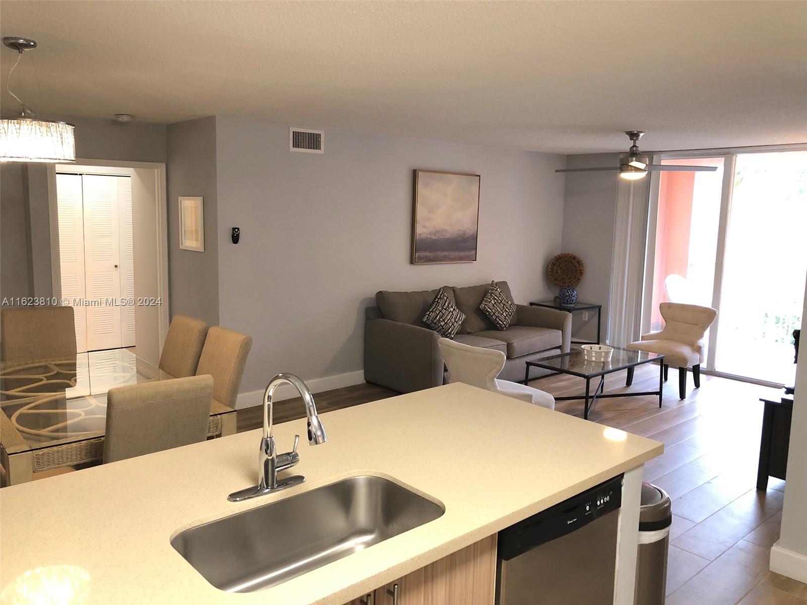 a kitchen with a table chairs and a refrigerator