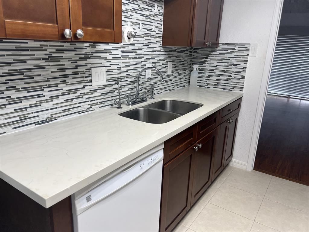 a kitchen with a sink cabinets and a wooden floor