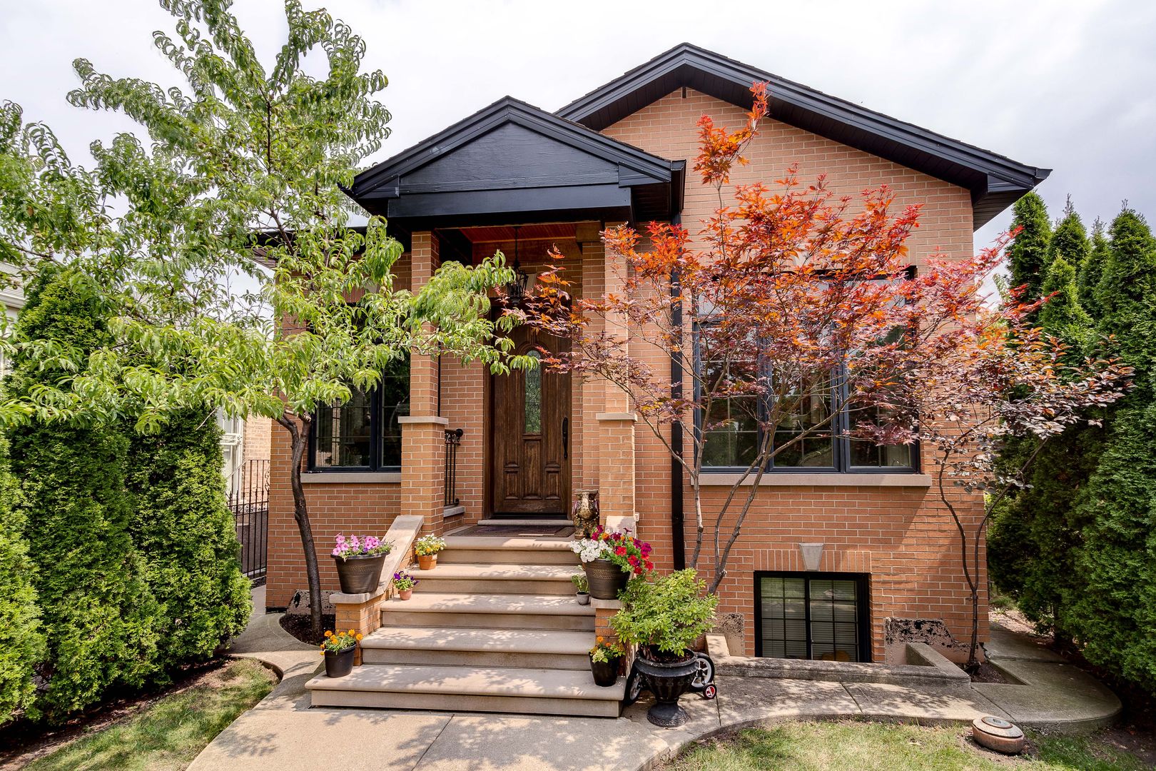 a front view of house with yard and trees around