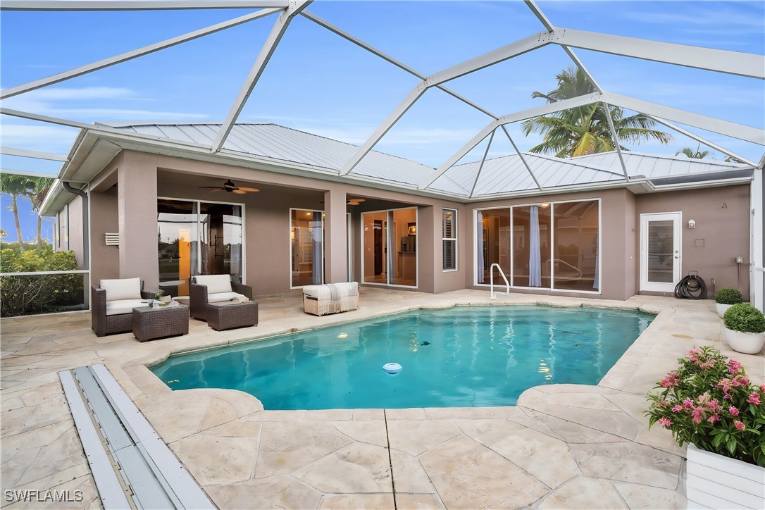 a view of a house with swimming pool and porch with furniture