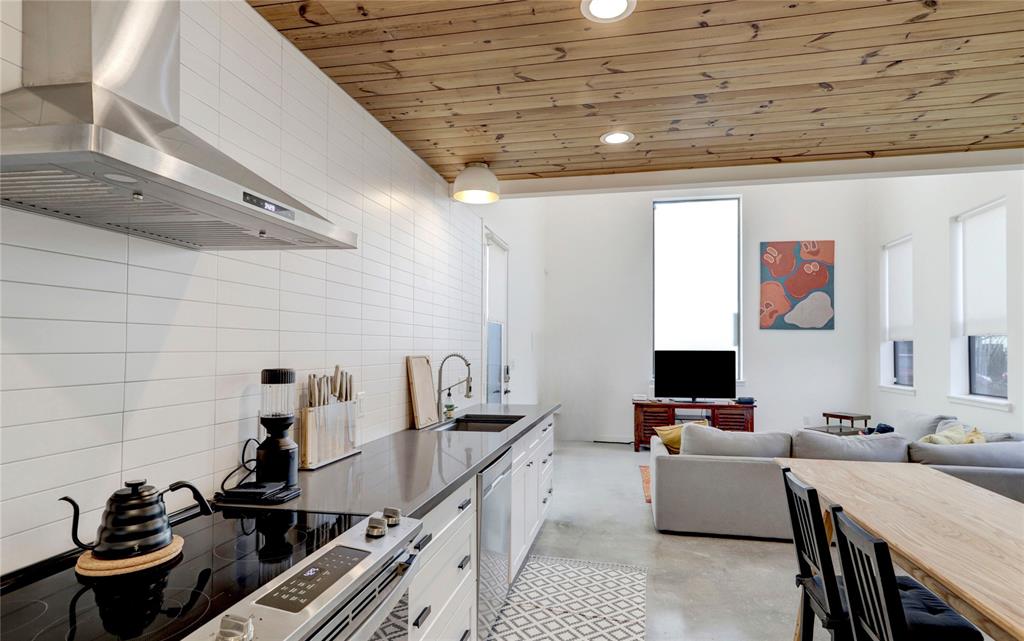 a kitchen with a sink appliances and cabinets