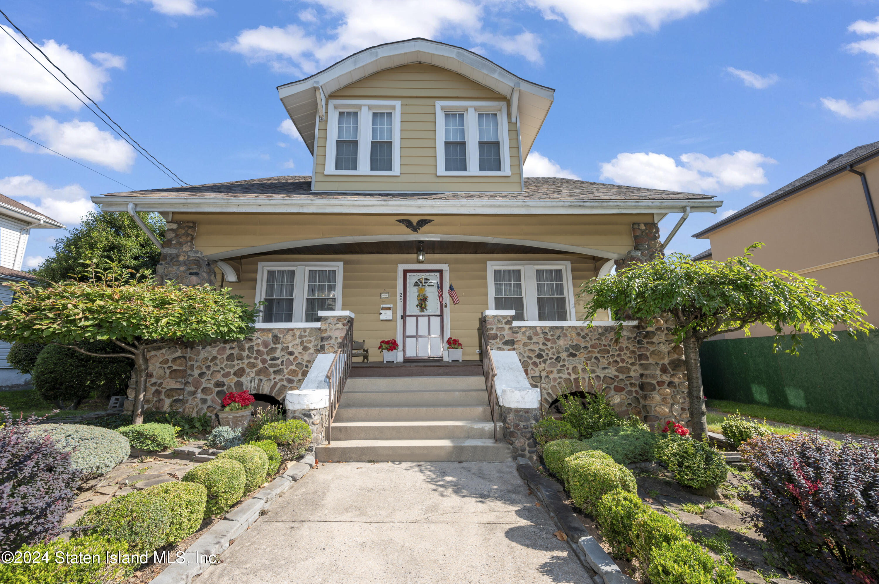 a front view of a house with a garden