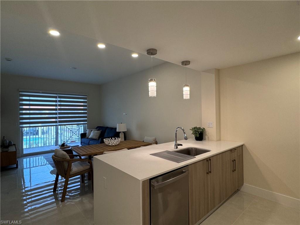 a kitchen with a sink and a stove top oven