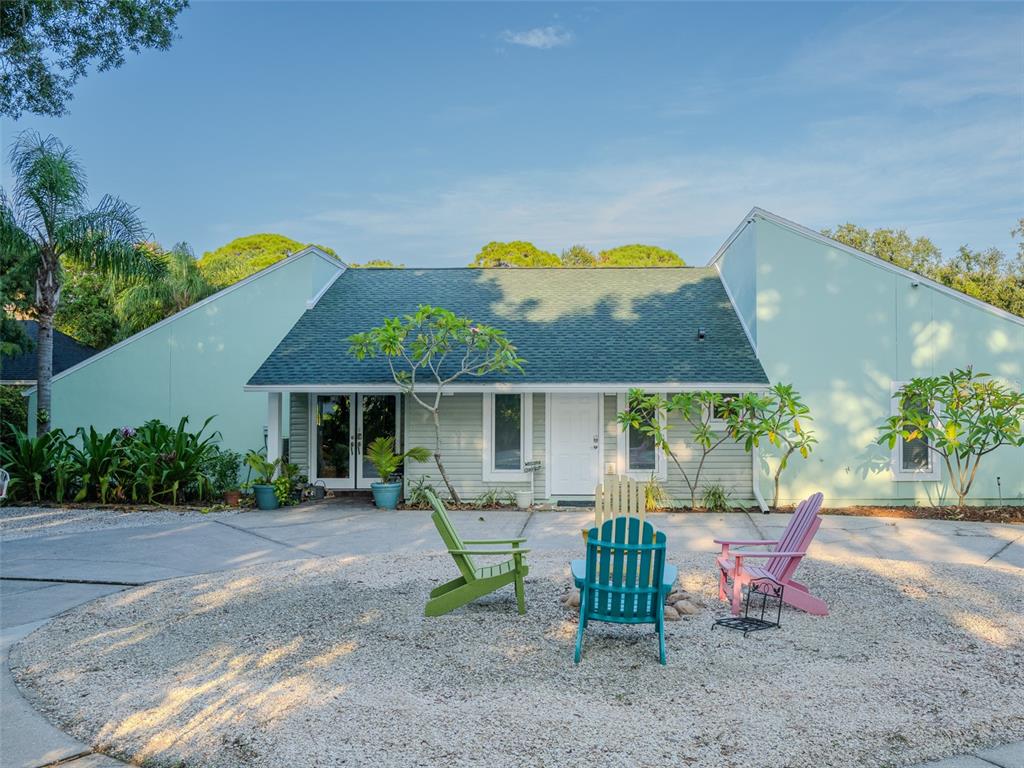 a view of a house with backyard and sitting area