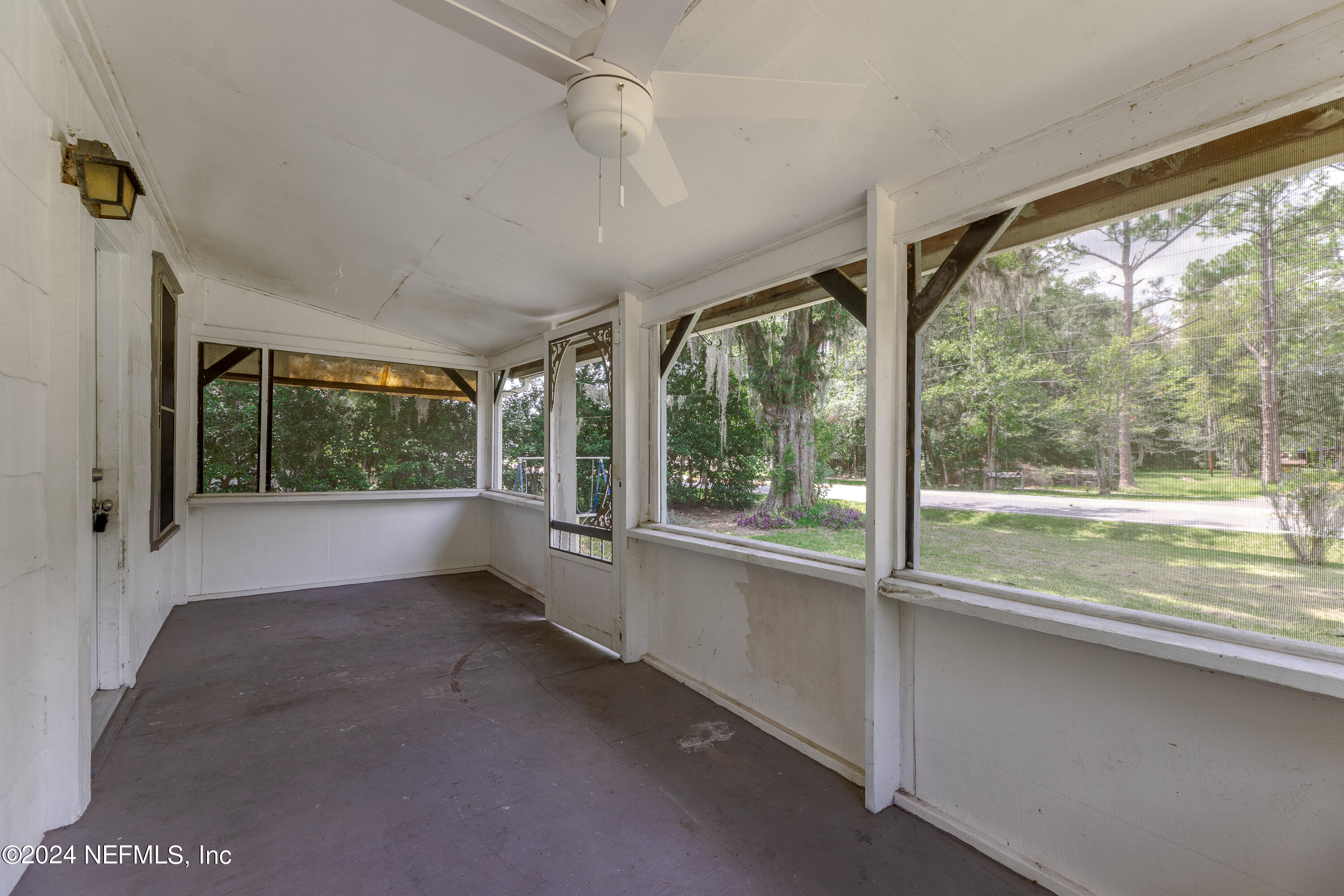 a view of an empty room with a window and a porch