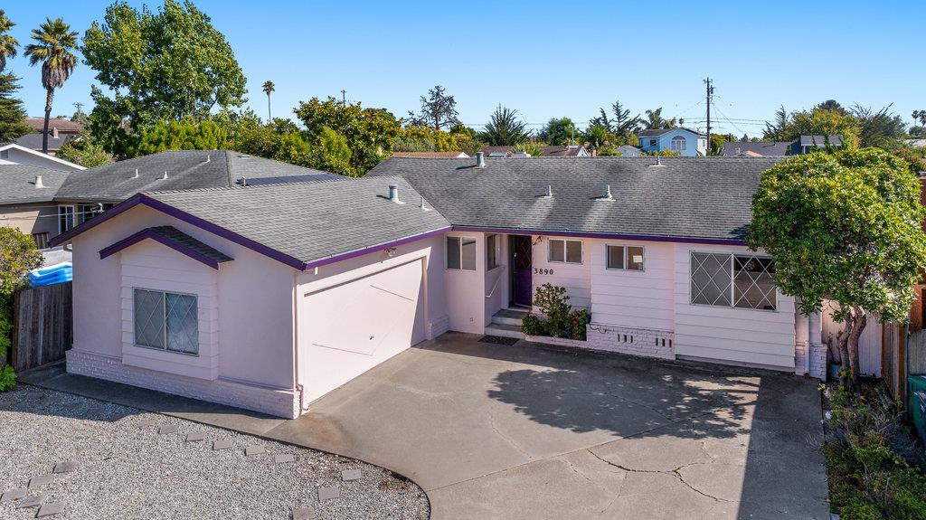 a aerial view of a house with a yard and garage