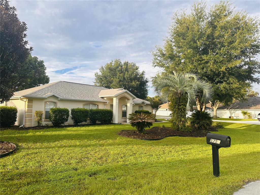 a front view of a house with a yard