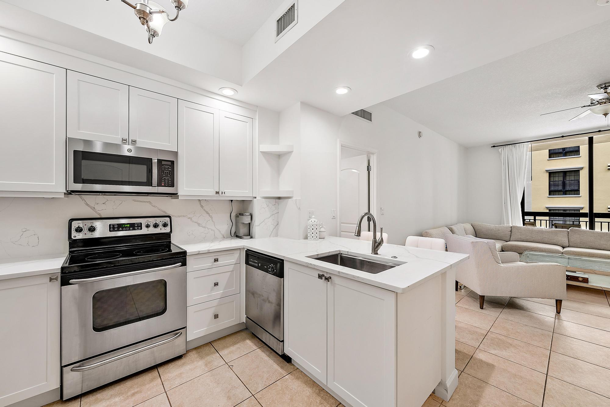 a kitchen with a stove a sink and a microwave