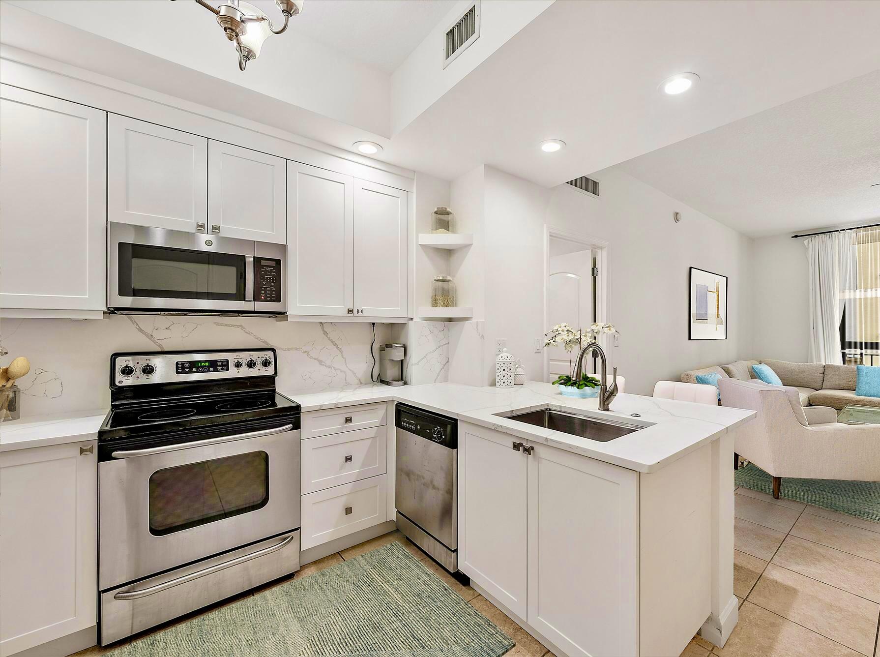 a kitchen with a sink stove and microwave