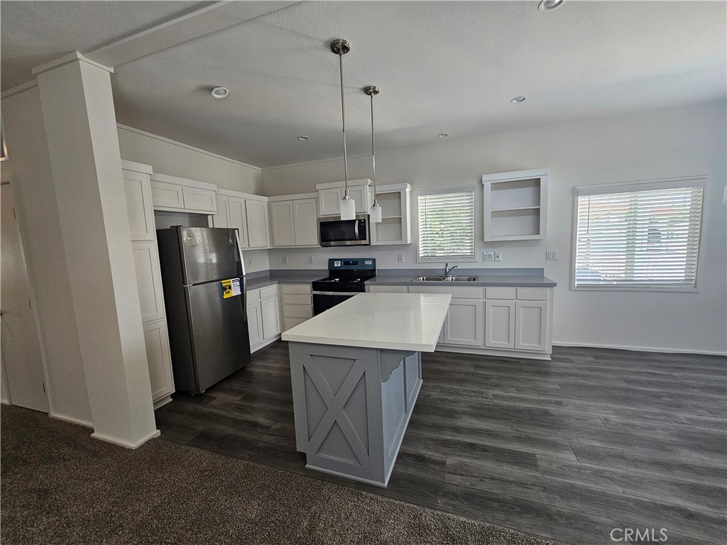 a kitchen with refrigerator cabinets and wooden floor