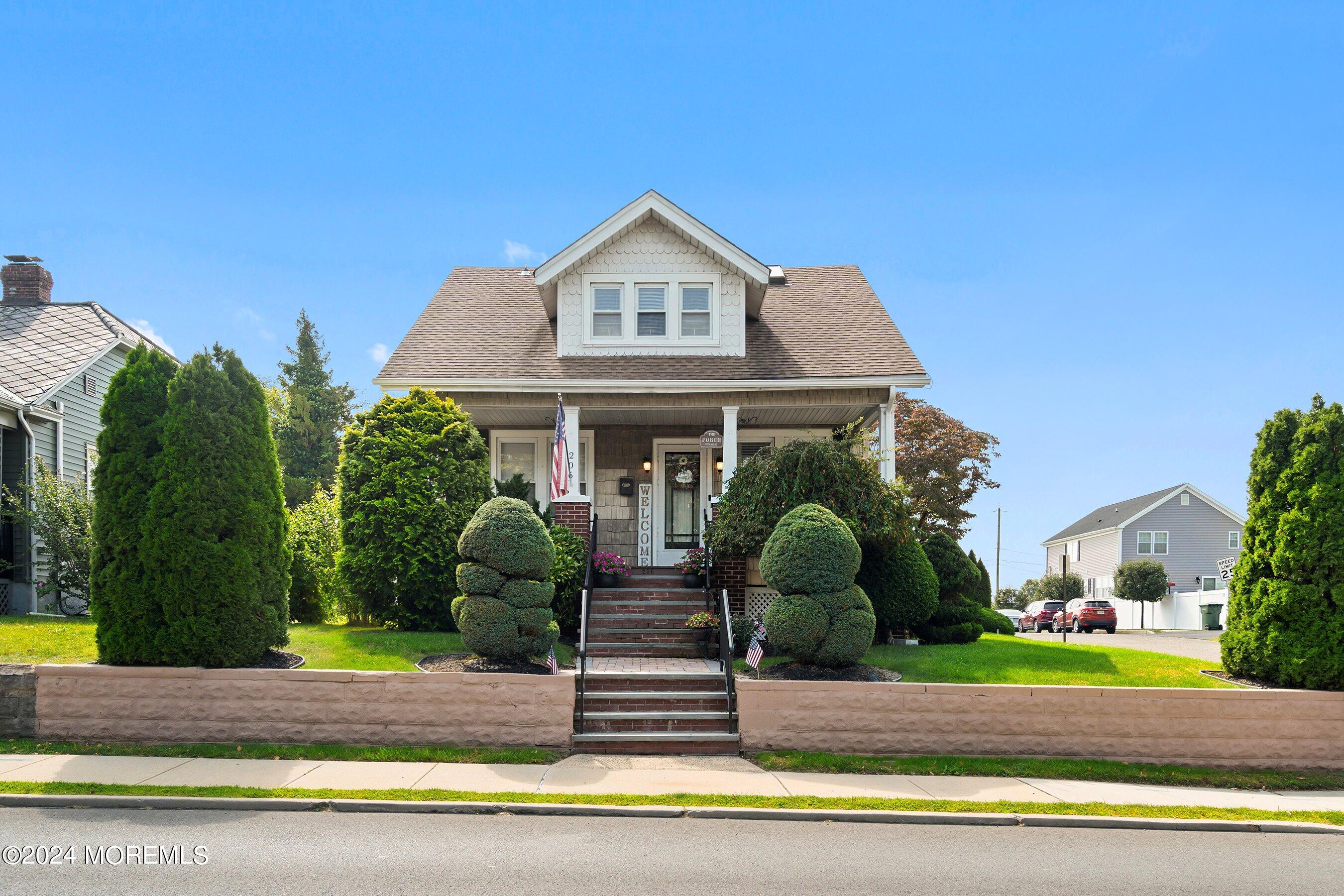 a front view of a house with garden