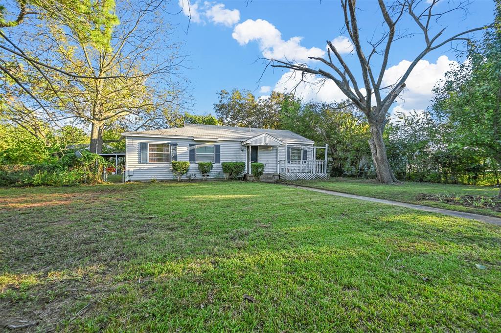 a view of house with yard and outdoor seating