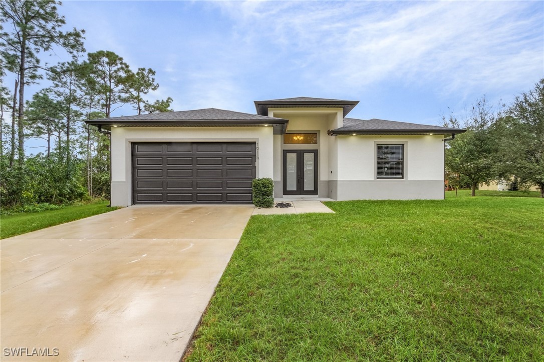 a front view of a house with a yard and garage