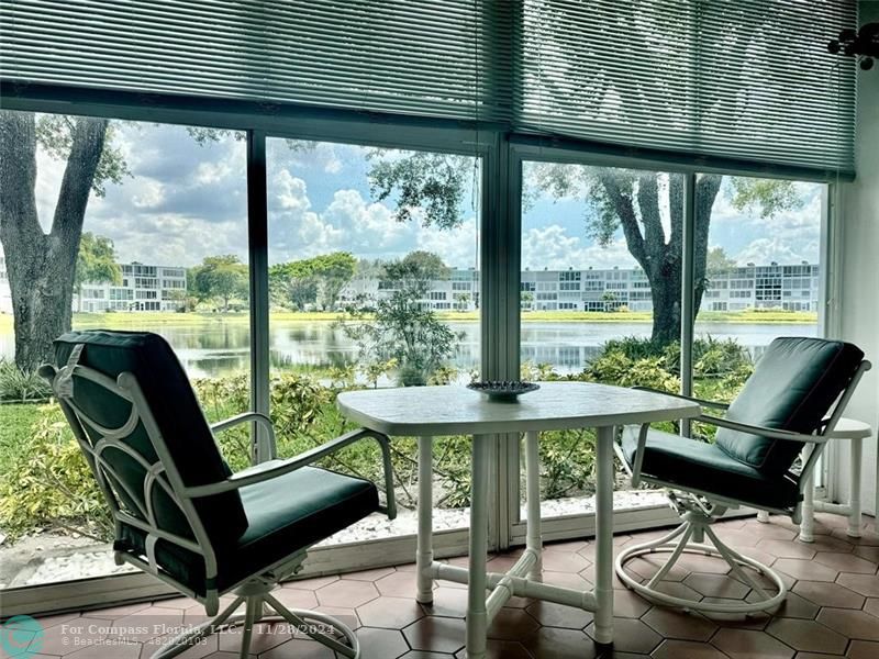 a view of a dining room with furniture wooden floor and a floor to ceiling window