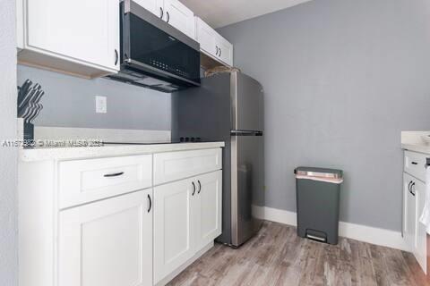 a kitchen with a refrigerator stove and microwave