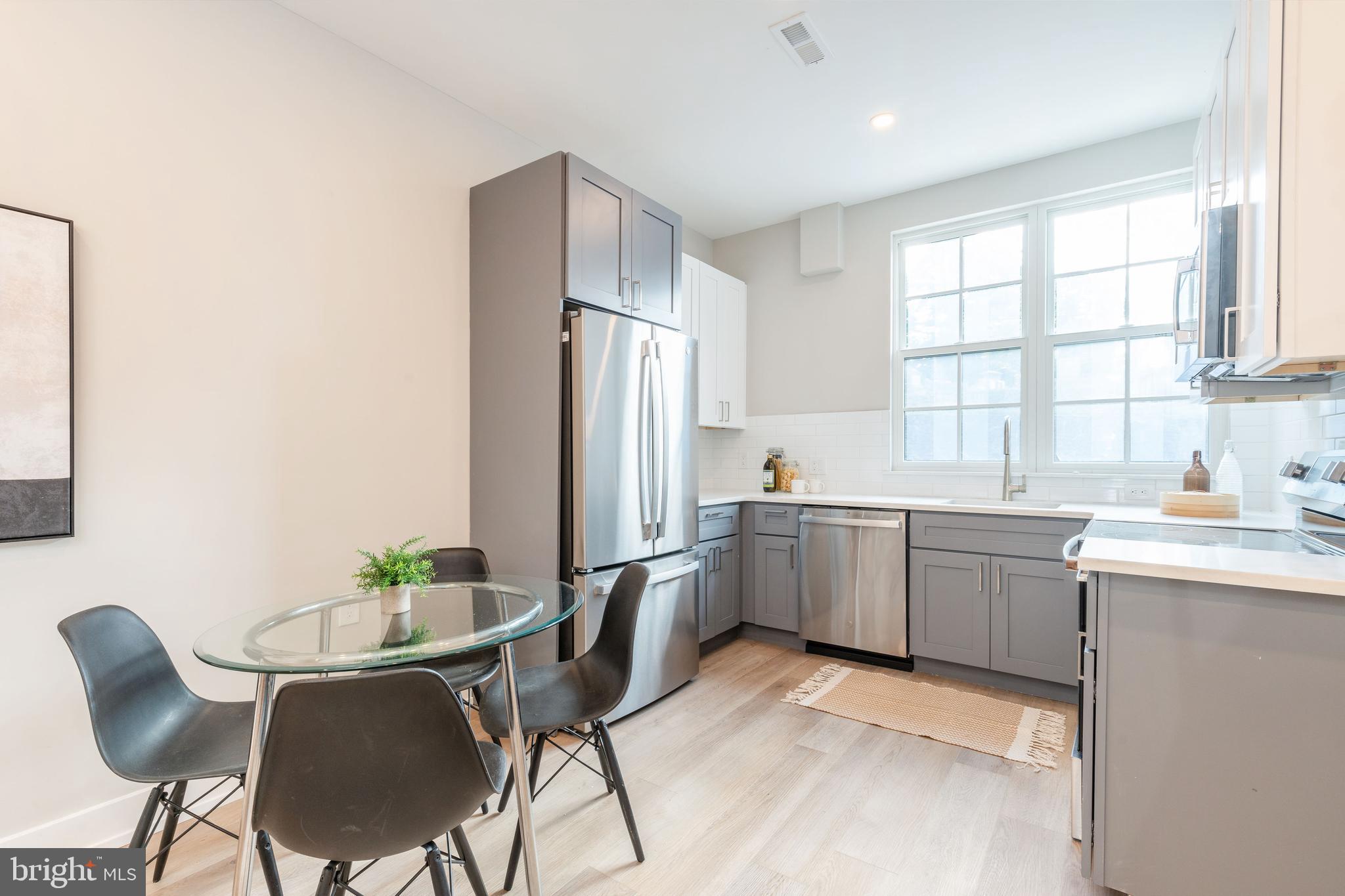 a kitchen with sink cabinets and refrigerator