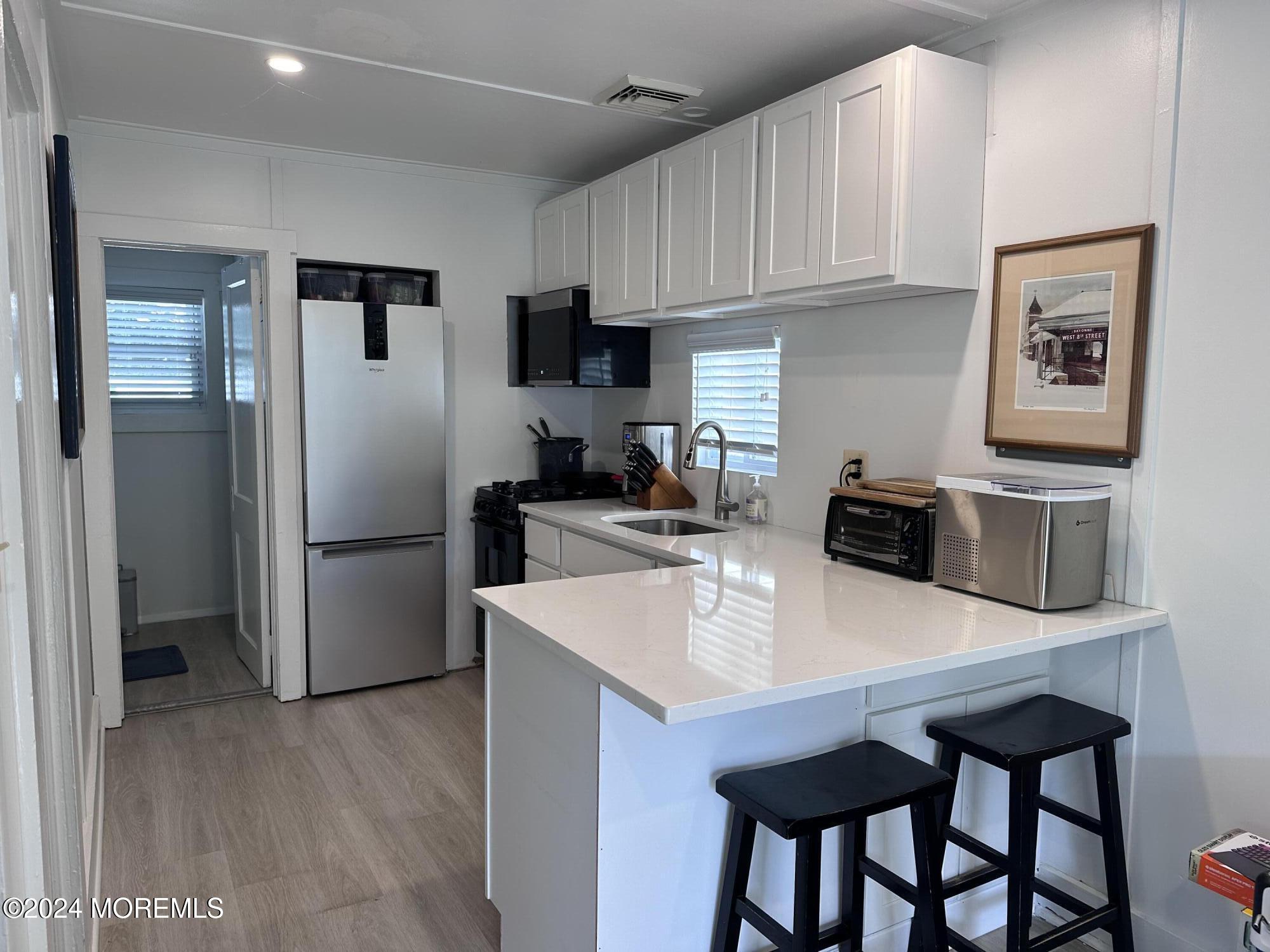 a kitchen with stainless steel appliances a refrigerator and a table