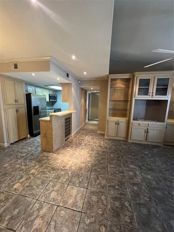 a view of kitchen with refrigerator and window