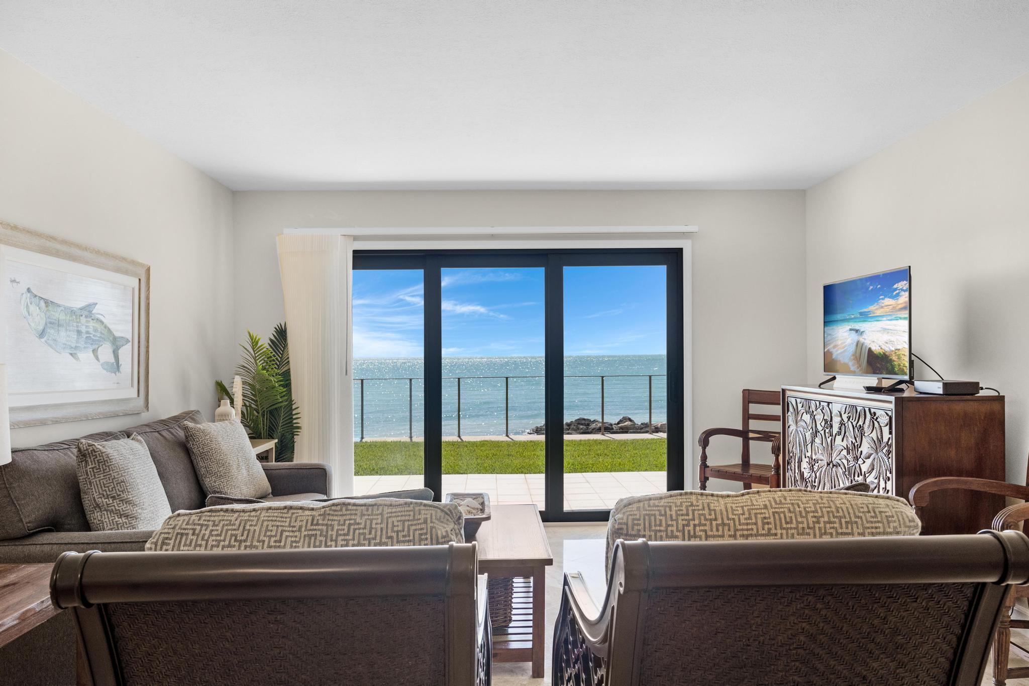 a living room with furniture and a floor to ceiling window