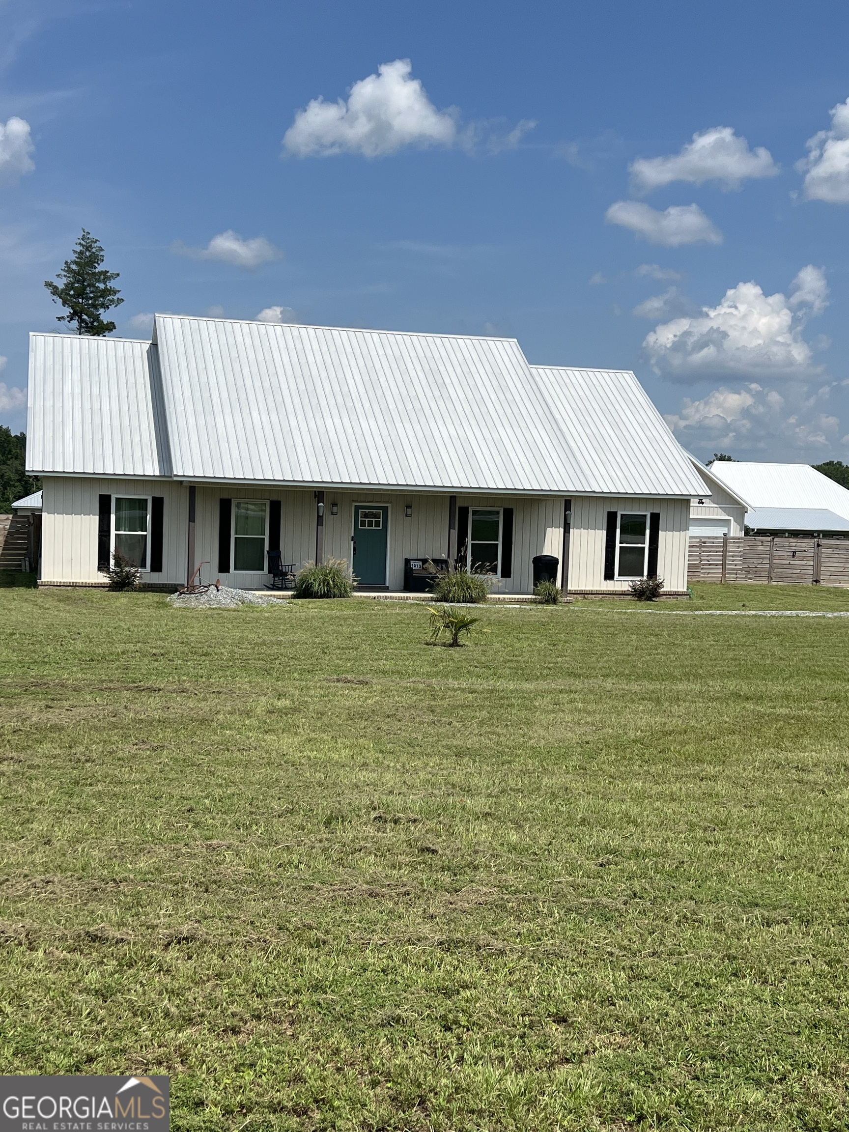 a front view of a house with a garden