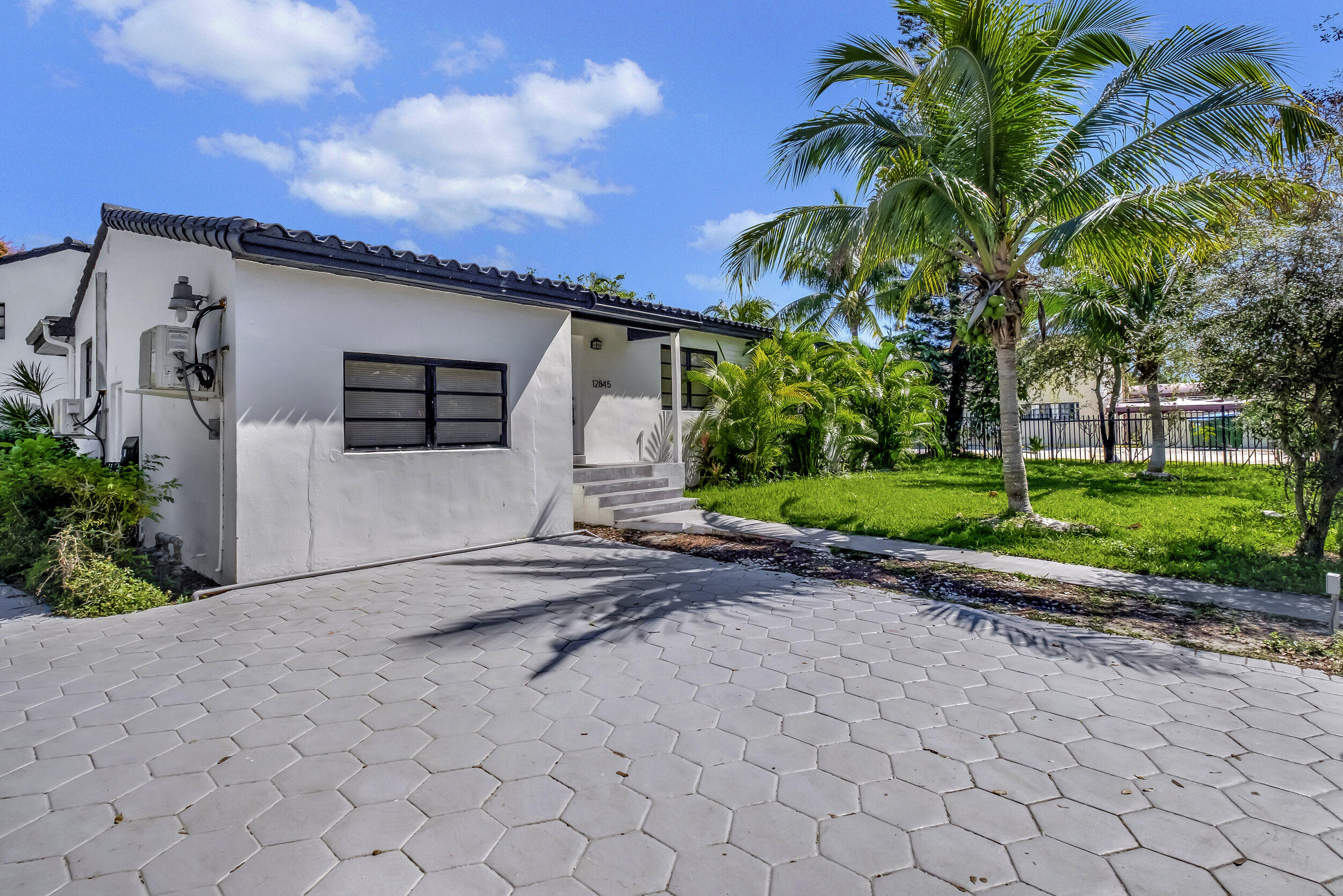 a house with palm tree in front of it